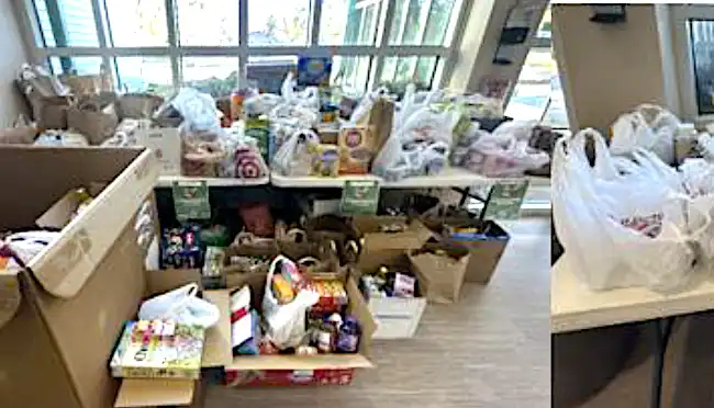 Bishop-Community-service-care-crew3crop Tables with heaps of grocery bags and boxes for donation, filling a bright room for a food drive scene.