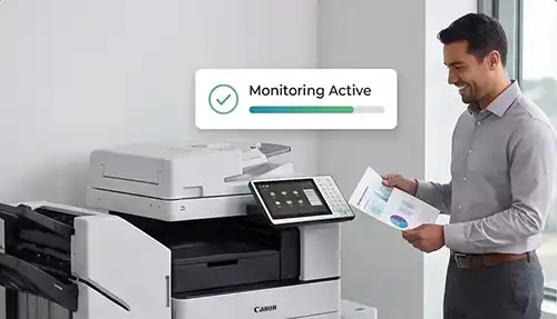 Man in business attire stands beside a Canon multifunction printer, reviewing reports as a 'Monitoring Active' status badge with a green progress bar appears above.